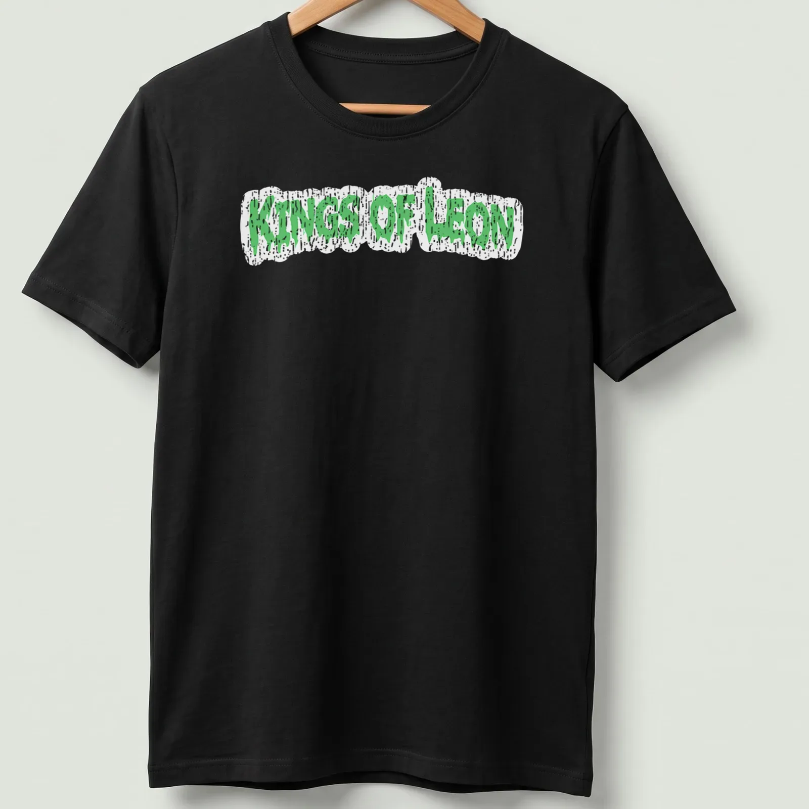 Grunge-style Kings Of Leon t-shirt with green dripping text design — printed on a unisex t-shirt