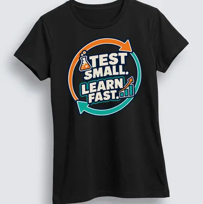 Bold graphic tee with 'TEST SMALL. LEARN FAST.' and laboratory flask illustration — printed on a women's shirt