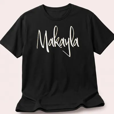 Elegant script t-shirt featuring the name Makayla in gold on white — printed on a unisex t-shirt