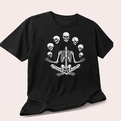 Halloween-themed t-shirt featuring a meditating skeleton with playful skulls. — printed on a unisex t-shirt (angled view)