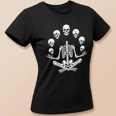 Halloween-themed t-shirt featuring a meditating skeleton with playful skulls. — printed on a women's shirt