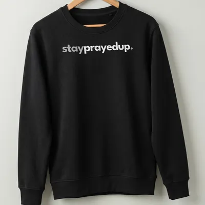 Minimalist design featuring the phrase stay prayed up in white and gray — printed on a unisex sweatshirt