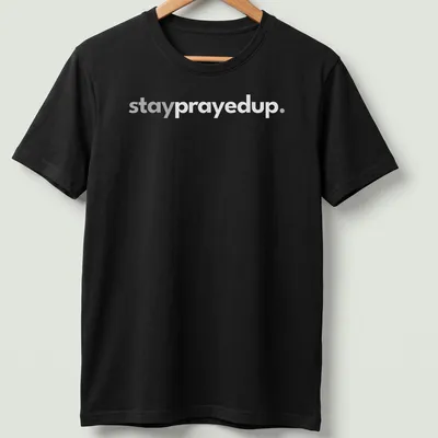 Minimalist design featuring the phrase stay prayed up in white and gray — printed on a unisex t-shirt