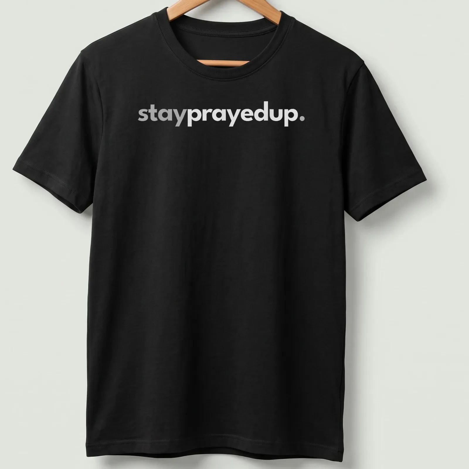 Minimalist design featuring the phrase stay prayed up in white and gray — printed on a unisex t-shirt