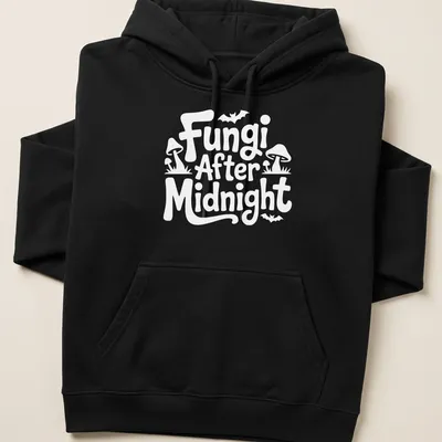 Whimsical illustration of mushrooms with 'Fungi After Midnight' text in purple, green, and blue. — printed on a unisex hoodie