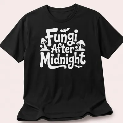 Whimsical illustration of mushrooms with 'Fungi After Midnight' text in purple, green, and blue. — printed on a unisex t-shirt