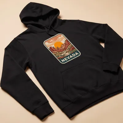 Retro print featuring a sunset over Nevada's desert canyon landscape — printed on a unisex hoodie