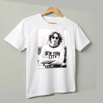 Black and white photograph of John Lennon with 'New York City' text — printed on a unisex t-shirt (angled view)
