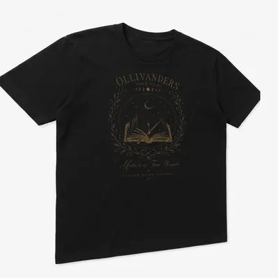 Vintage illustration of Ollivanders with wand and book in gold and cream — printed on a unisex t-shirt (angled view)