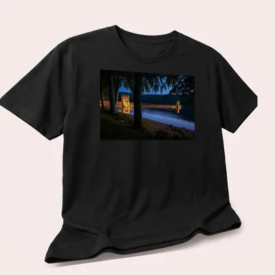 Photographic T-shirt featuring Derwent Dam illuminated at twilight in blue and gold — printed on a unisex t-shirt (angled view)