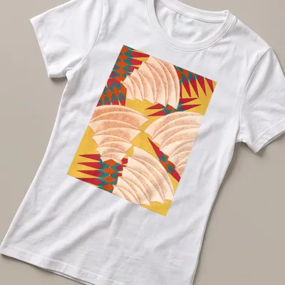 Abstract pineapple pattern t-shirt in yellow, red, teal, orange, and white — printed on a women's shirt