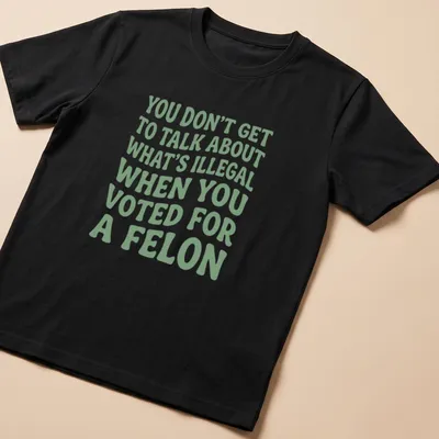 Bold political commentary t-shirt with playful typography in green and white — printed on a unisex t-shirt
