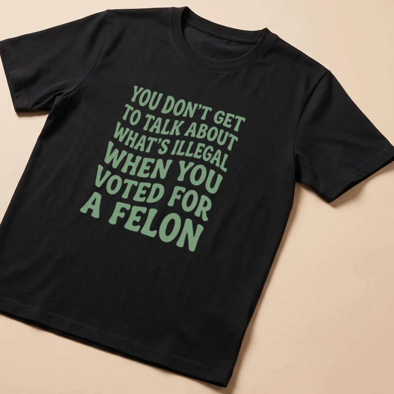 Bold political commentary t-shirt with playful typography in green and white — printed on a unisex t-shirt