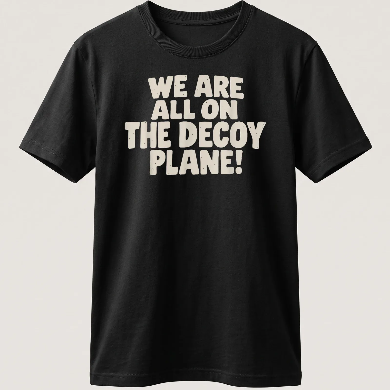 Bold typography t-shirt with the phrase 'We Are All On The Decoy Plane!' in beige and cream. — printed on a unisex t-shirt