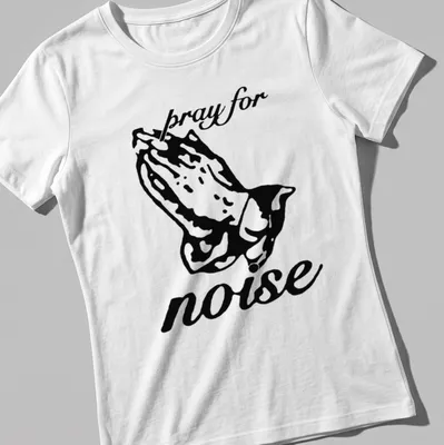 Bold black silhouette of praying hands with the text 'pray for noise' underneath — printed on a women's shirt