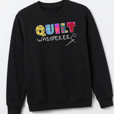 Colorful patchwork design with floral patterns spelling Quilt Whisperer — printed on a unisex sweatshirt