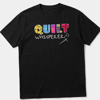 Colorful patchwork design with floral patterns spelling Quilt Whisperer — printed on a unisex t-shirt