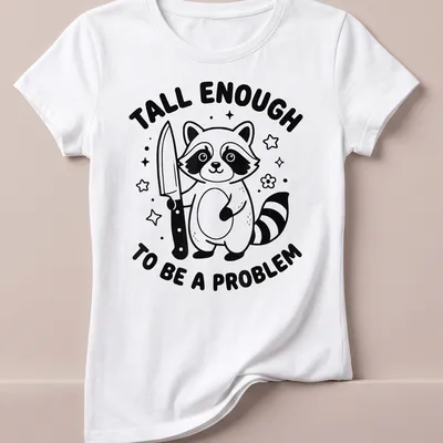 Kawaii line-art t-shirt featuring a raccoon and the text 'Tall Enough To Be A Problem' — printed on a women's shirt
