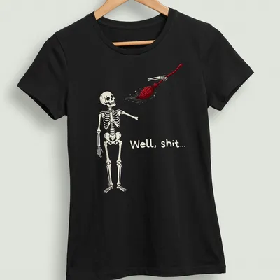Cartoon skeleton holding broom with humorous text above in beige, red, and black — printed on a women's shirt