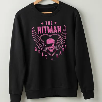 Retro distressed shirt featuring a skull with wings and Bret Hart's name in pink and white — printed on a unisex sweatshirt