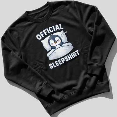 Kawaii cartoon of a sleeping penguin with the text 'Official Sleepshirt' above. — printed on a unisex sweatshirt