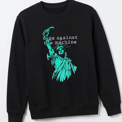 Vintage-style tee featuring the Statue of Liberty with Rage Against the Machine text in turquoise and black — printed on a unisex sweatshirt