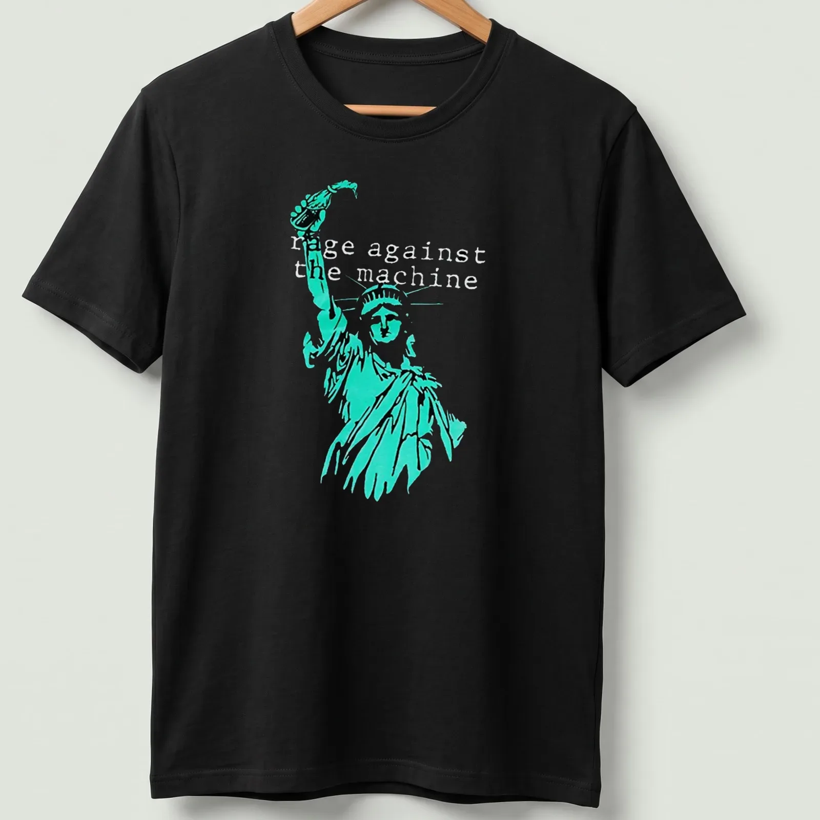 Vintage-style tee featuring the Statue of Liberty with Rage Against the Machine text in turquoise and black — printed on a unisex t-shirt