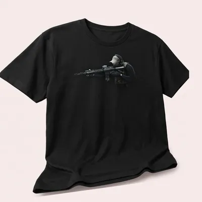 Realistic print of a tactical soldier with a rifle in black, green, tan, and gray — printed on a unisex t-shirt (angled view)