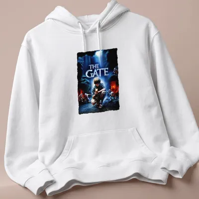 Horror movie poster-style t-shirt featuring a boy with a flashlight and the text 'THE GATE' — printed on a unisex hoodie