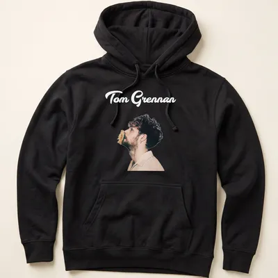 Illustration of Tom Grennan in modern portrait style with text in black, beige, and brown. — printed on a unisex hoodie