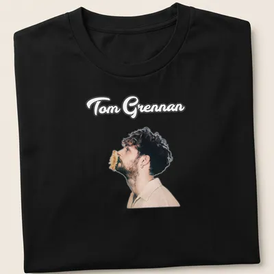 Illustration of Tom Grennan in modern portrait style with text in black, beige, and brown. — printed on a unisex t-shirt