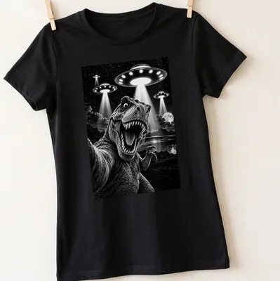 Funny T-shirt with Tyrannosaurus Rex taking a selfie with UFOs in black and white — printed on a women's shirt