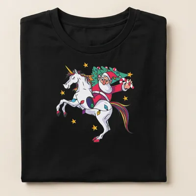 Cartoon Santa riding a unicorn with Merry Christmas text in colorful design — printed on a women's shirt