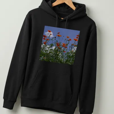 Photographic print of vibrant orange wildflowers against a blue sky — printed on a unisex hoodie