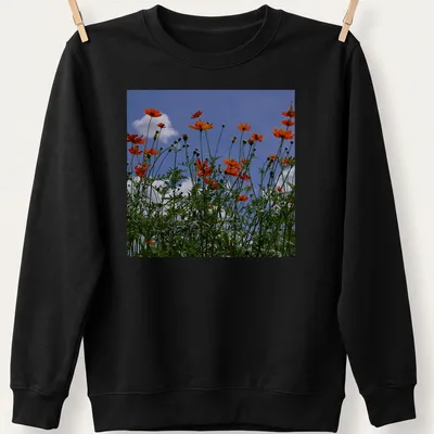 Photographic print of vibrant orange wildflowers against a blue sky — printed on a unisex sweatshirt