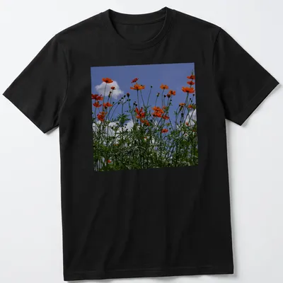 Photographic print of vibrant orange wildflowers against a blue sky — printed on a unisex t-shirt