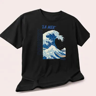 Japanese ukiyo-e style illustration of a wave with 'LA MER' text in blue and white — printed on a unisex t-shirt (angled view)