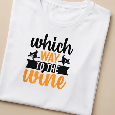 Illustration of a witch on a broomstick with text asking for wine direction in Halloween colors — printed on a women's shirt