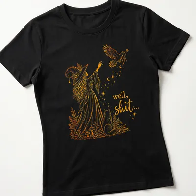 Whimsical line-art of a witch with a crow and magic wand, with text below. — printed on a women's shirt
