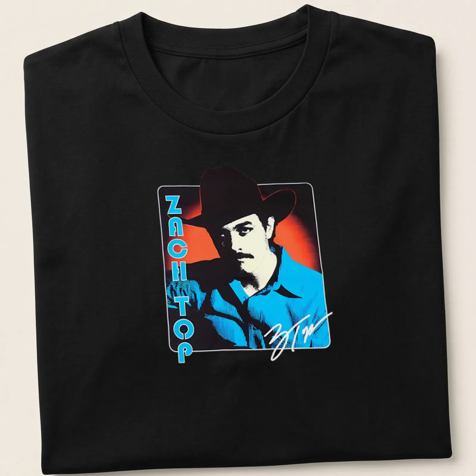 Bold retro cowboy graphic with the phrase Zach Top in blue, red, black, and white — printed on a unisex t-shirt